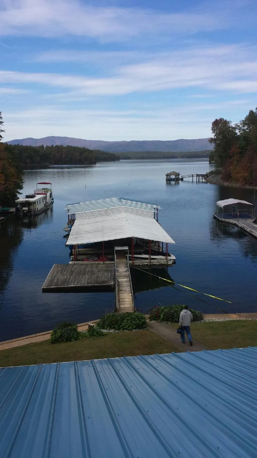 View across a lake from a newly installed blue metal roof in Orefield